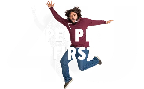 happy man jumping in front a of a logo saying "People First"