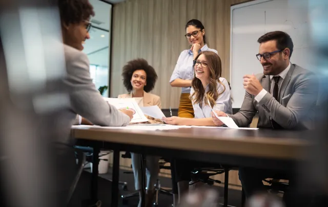 People in a meeting talking and laughing
